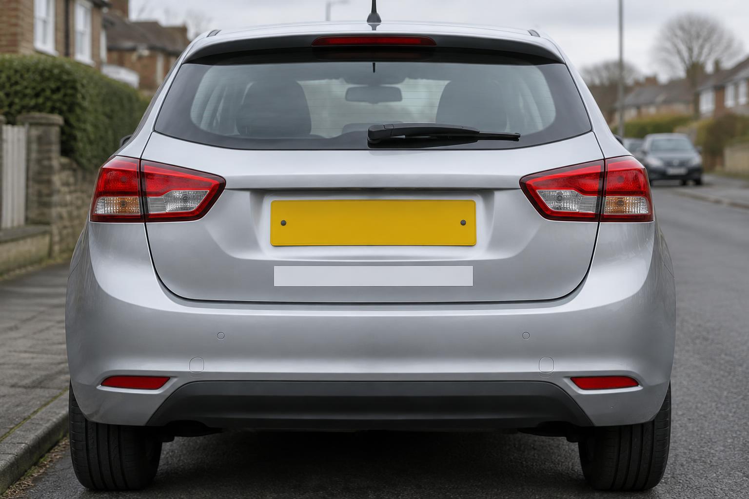 Rear of a car with the two ideal magnetic sign zones marked: above and below the number plate